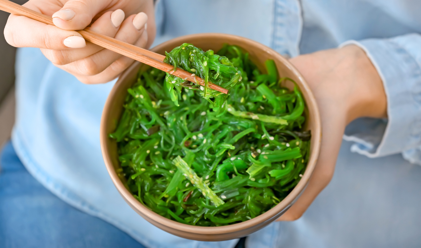 person eating seaweed salad